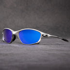 A pair of silver-framed polarized sunglasses with blue mirrored lenses is displayed on a textured gray surface, with a dark gray background—perfect outdoor eyewear offering stylish UV protection.